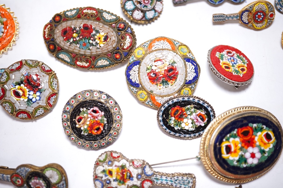 A collection of twenty-eight brooches, including fourteen mixed guitar and banjo shaped brooches, six large oval brooches, seven smaller brooches and one small oval., Condition - good